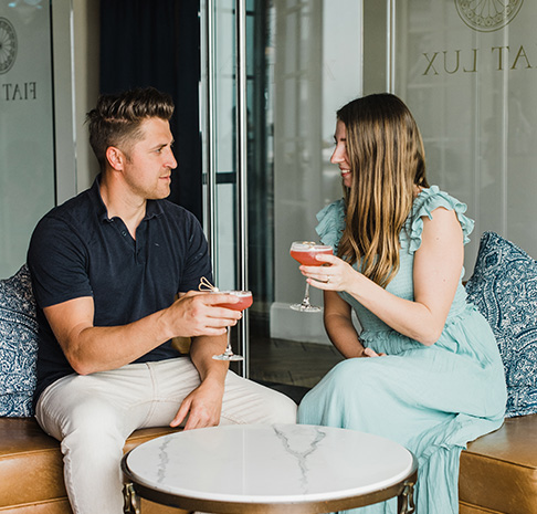 Couple with cocktails in hand