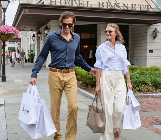 A couple with Gwynn's shopping bags outside of Hotel Bennett