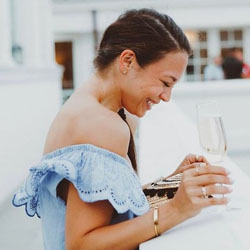 A woman holding a champage flute smiling