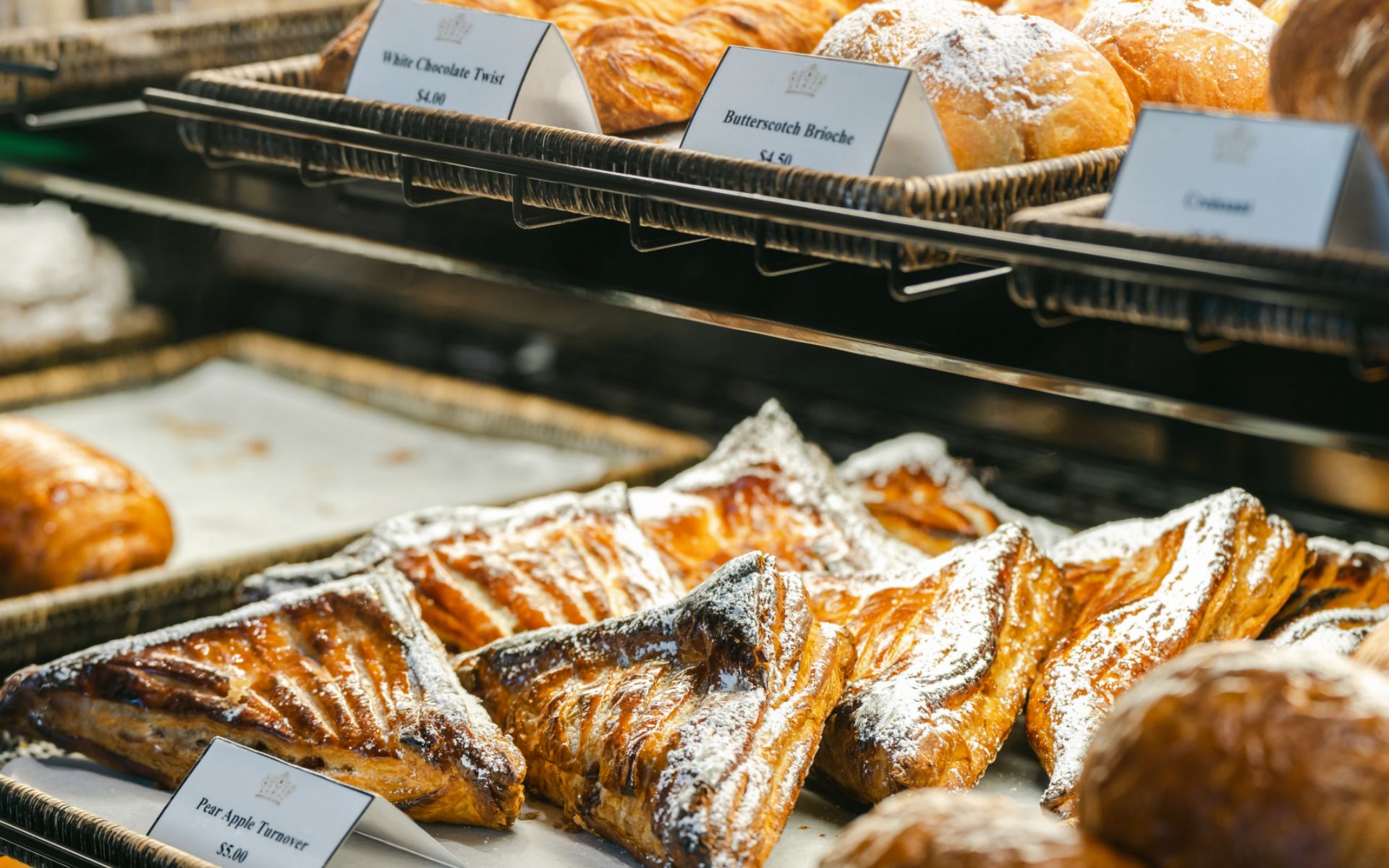A closeup of several pastries in the display window